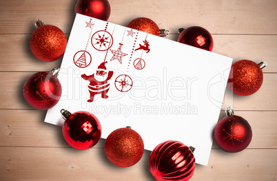 Composite image of hanging red christmas decorations