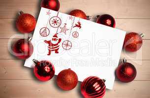 Composite image of hanging red christmas decorations