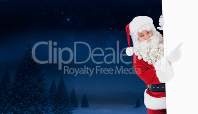 Composite image of smiling santa claus pointing poster