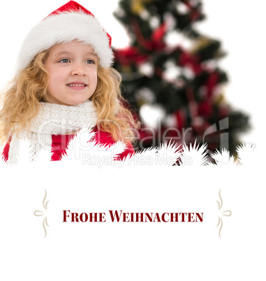 Composite image of festive little girl in santa hat and scarf