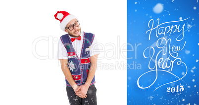 Composite image of geeky hipster in santa hat