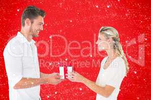 Composite image of young couple with gift