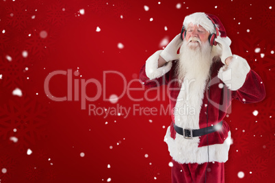 Composite image of santa claus enjoys some music