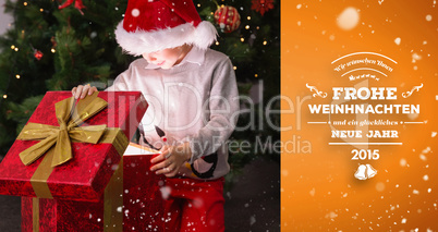 Composite image of child opening his christmas present