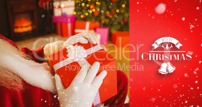 Composite image of santa claus holding a red gift