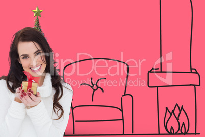 Composite image of portrait of a brunette holding gild gift