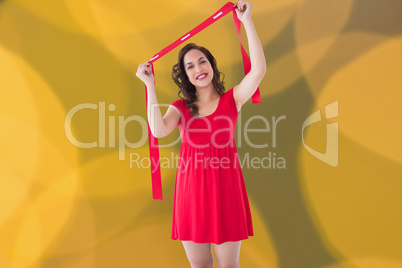 Composite image of stylish brunette in red dress holding scarf