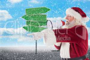 Composite image of santa points at something and uses a megaphon