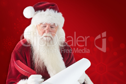 Composite image of santa writes something with a feather