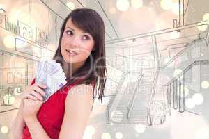 Composite image of festive brunette showing fan of dollars