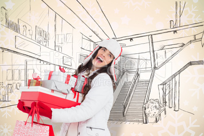 Composite image of brunette in winter clothes holding many gifts