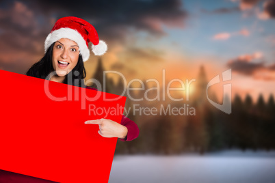 Composite image of woman pointing at sign