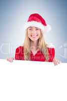 Pretty santa girl smiling at camera with poster