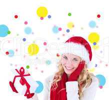 Composite image of happy festive blonde with gift
