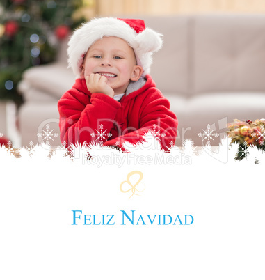 Composite image of festive little boy smiling at camera