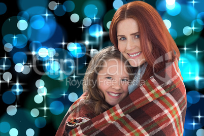 Composite image of mother and daughter under blanket