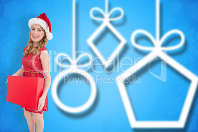 Composite image of smiling woman in santa hat holding box Composite image of smiling woman in santa hat holding box