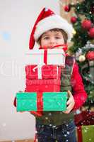 Composite image of cute festive little boy smiling at camera