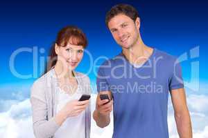 Composite image of couple using their mobile phones