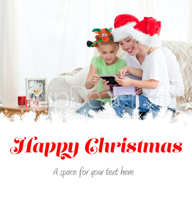 Mother and children looking at a calendar sitting on the sofa