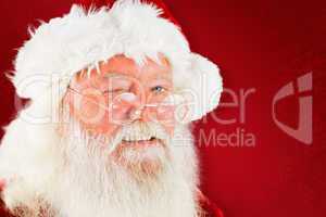 Composite image of santa claus winking