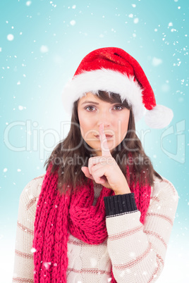 Composite image of festive brunette keeping a secret