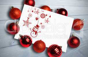 Composite image of hanging red christmas decorations