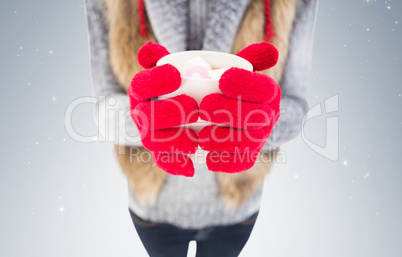 Woman in winter clothes holding a mug