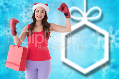 Composite image of festive brunette in boxing gloves with shoppi