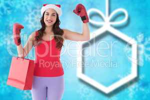 Composite image of festive brunette in boxing gloves with shoppi