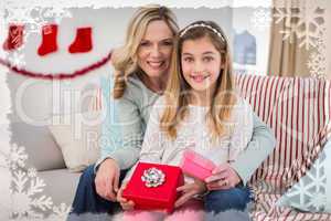 Composite image of daughter opening christmas gift with mother