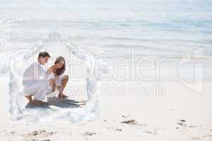 Composite image of cute couple drawing a heart in the sand