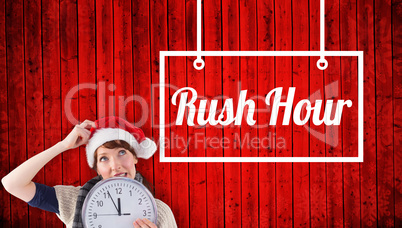 Composite image of woman holding a large clock