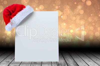 Composite image of santa hat on poster