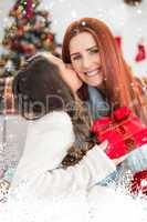 Composite image of daughter giving her mother a christmas present