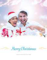 Composite image of festive young couple holding gift