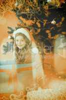 Composite image of festive little girl sitting in large gift