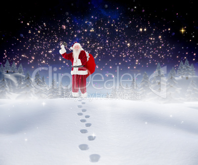 Composite image of santa walking in the snow