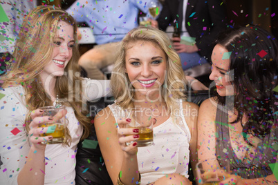 Composite image of pretty friends having a drink together