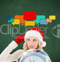 Composite image of happy festive blonde with clock