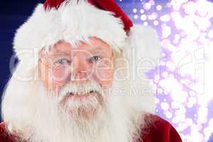 Composite image of santa smiling at camera