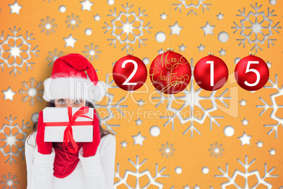 Composite image of brunette in red gloves and santa hat showing