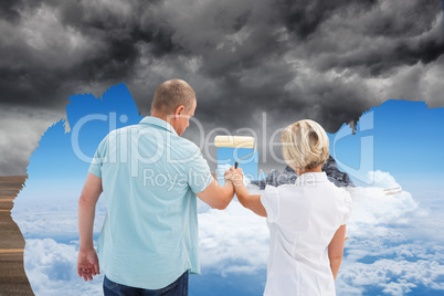 Composite image of happy older couple painting together