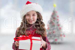 Composite image of cute girl looking at gift
