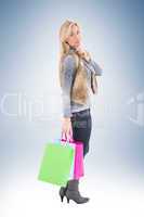 Blonde in winter clothes holding shopping bags