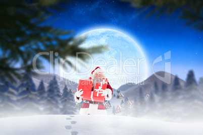 Composite image of santa carrying gifts in the snow