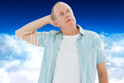 Composite image of thoughtful older man looking up