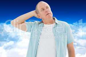 Composite image of thoughtful older man looking up