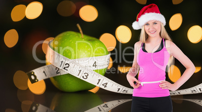 Composite image of fit festive young blonde measuring her waist