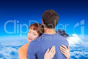Composite image of happy couple hugging one another